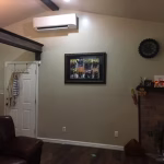 Professional ductless HVAC system installation in a residential living room by Roman expert technicians
